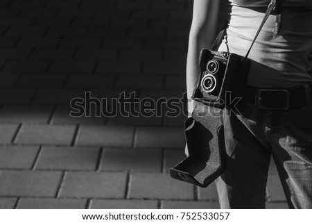 Girl with vintage analog camera. Black and white.  Copy space. 