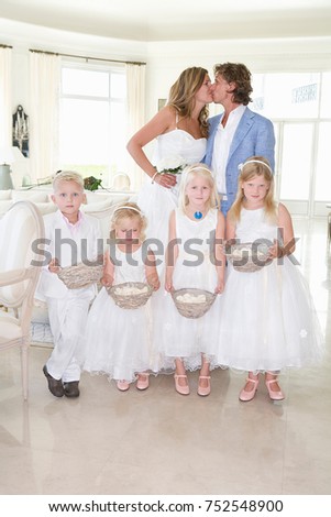 Wedding couple kiss with kids