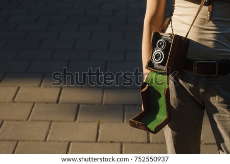 Girl with vintage analog camera. Copy space.