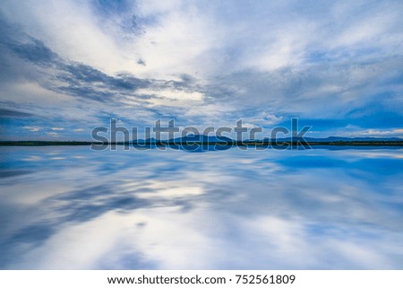 Sky clouds with reflection on water.