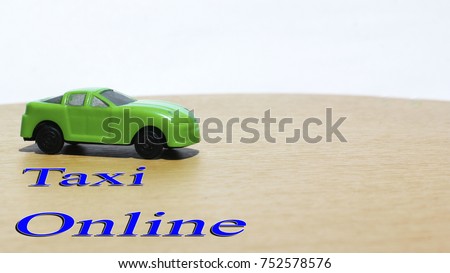 Green toy car taxi online text concept with copy space