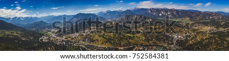 Scenic valley and snow-covered peaks under a blue sky with clouds in Estes Park, Colorado near the Rocky Mountain National Park. Aerial view from summit of Prospect Mountain. Royalty-Free Stock Photo #752584381