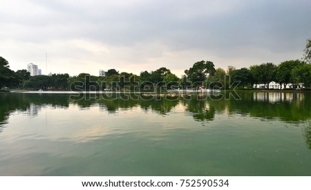 Bangkok city landscape from Lumpini park in the evening with reflection.2 