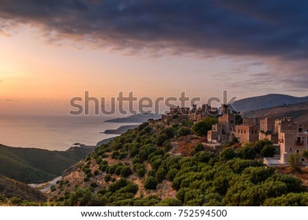 Amazing colorful sunset over the architectural and historical towers dominating the area at the famous Vatheia village in the Laconian Mani peninsula. Laconia prefecture, Peloponnese, Greece, Europe.