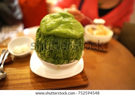 Close up Matcha Green tea Kakigori (Japanese shaved ice dessert flavored with sweet syrup and toppings)