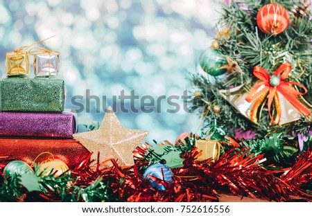 Christmas decorations with star,gift boxes and bell on christmas tree background