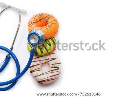 Unhealthy eating, Junk-food, Sweet food and Fast food Concept - Donuts with stethoscope. isolated on white background.
