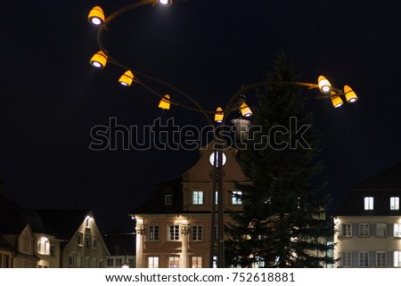 citylights at night with facades and architecture of a marketplace in a historical city of south germany in autumn month of november before christmas time