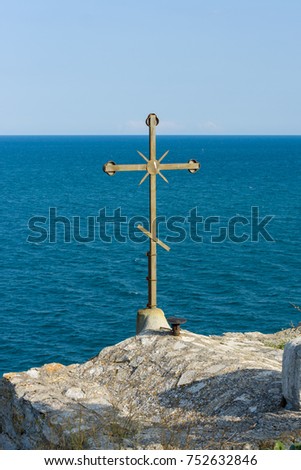 Bulgaria. Cape Kaliakra. Orthodox cross over the chapel of St. Nicholas the Wonderworker against the blue sea.