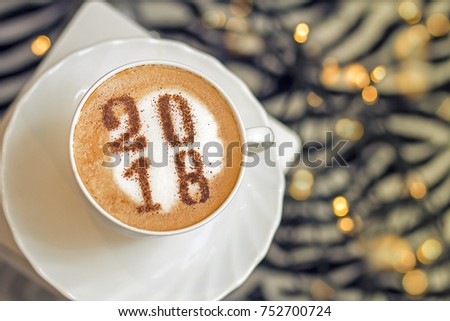 festive New Year's coffee in a white cup with an inscription from cinnamon 2018 Royalty-Free Stock Photo #752700724