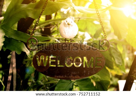 signs of welcome text with nature background and sunlight 