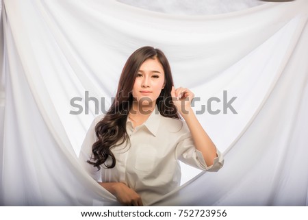 Portrait of a happy woman standing on a white background.