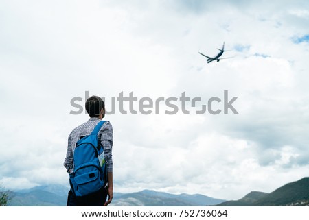 Tourist/ traveler Standing Alone and Watching Plane Taking Off. Travel Concept. Royalty-Free Stock Photo #752736064