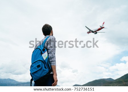 Tourist/ traveler Standing Alone and Watching Plane Taking Off. Travel Concept. Royalty-Free Stock Photo #752736151