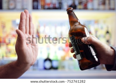 Hand rejecting alcoholic beer beverage concept for alcoholism and addiction Royalty-Free Stock Photo #752761282