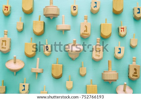 Top view Image of jewish holiday Hanukkah with wooden dreidels colection (spinning top).