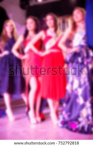Blurred for background. Ibiza club fashion show. Nightclub show. Fashion show on stage with many in audience. Large crowd of people having fun in a nightclub during the show.