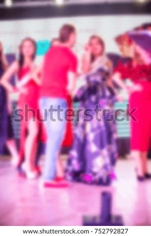 Blurred for background. Ibiza club fashion show. Nightclub show. Fashion show on stage with many in audience. Large crowd of people having fun in a nightclub during the show.
