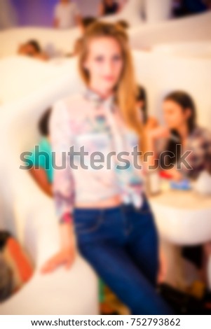 Blurred for background. Ibiza club fashion show. People smiling and posing on cam during concert in night club party. Man and woman have fun at club. Boy and girl at night club party