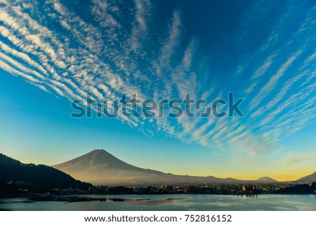 Morning sunlight at the peak of Mount Fuji on a bright sky day and the city around kawaguchiko lake in japan. 