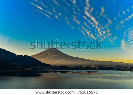 Morning sunlight at the peak of Mount Fuji on a bright sky day and the city around kawaguchi lake in japan. 