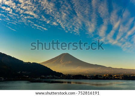Morning sunlight at the peak of Mount Fuji on a bright sky day and the city around kawaguchi lake in japan. 