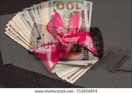 A gift in a pink wrap and background calculator.
