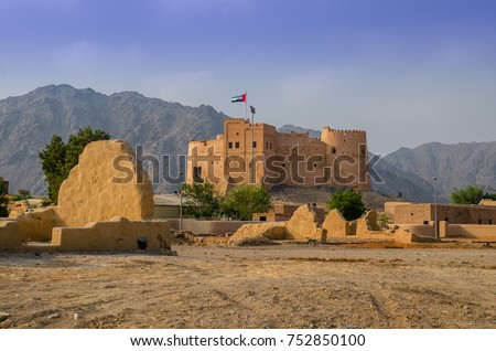 Fujairah fort with a view of ancient village ruins.This fort was built from local materials involving stone, gravel, clay, hay, and gypsum. Royalty-Free Stock Photo #752850100