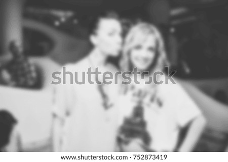 Blurred for background. night club party. People smiling and posing on cam during concert in night club party. Man and woman have fun at club. Boy and girl at night club party
