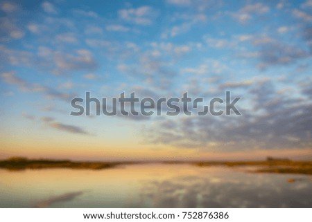 burred background of beautiful sunrise with reflection in water
