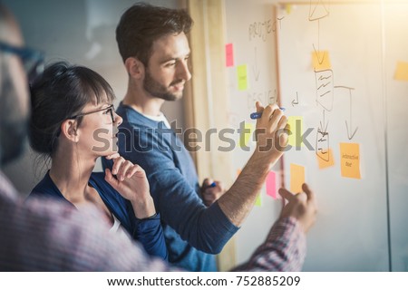 Business people meeting at office and use post it notes to share idea. Brainstorming concept. Sticky note on glass wall. Royalty-Free Stock Photo #752885209