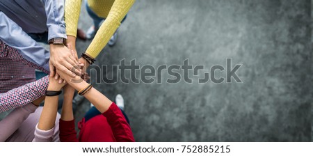 Close up top view of young business people putting their hands together. Stack of hands. Unity and teamwork concept. Royalty-Free Stock Photo #752885215