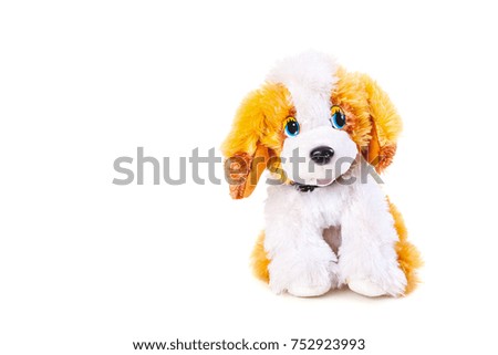 dog is a symbol of 2018. Beautiful soft toy dog with red ears sits on a white background close-up
