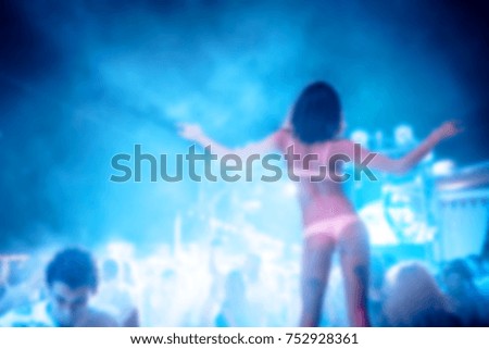 Blurred for background. night club party. Night club dj party people enjoy of music dancing sound with colorful light with Smoke Machine and lights show. Hands up in the earth.