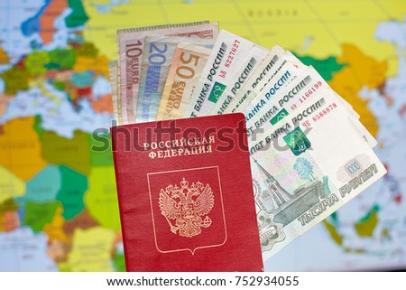 a Russian passport with euro banknotes and rubles on the background of the world map
