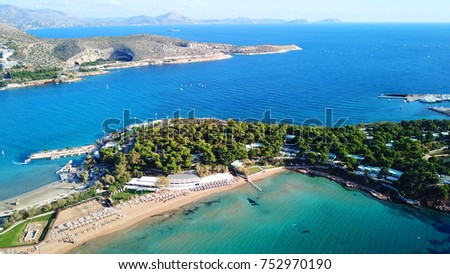 Aerial drone bird's eye photo of famous celebrity sandy beach of Astir or Asteras in south Athens riviera with turquoise clear waters, Vouliagmeni, Greece