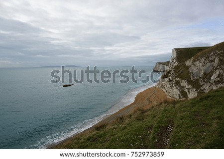 The wonderful cliff locates in UK. It has beach and sea all around the cliff. We have to walk up on top to take this photo. It is very beautiful photo.