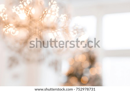 Silhouette of snowflakes on the background of a New Year tree. Christmas background. Blurred image of a decorated interior for Christmas.