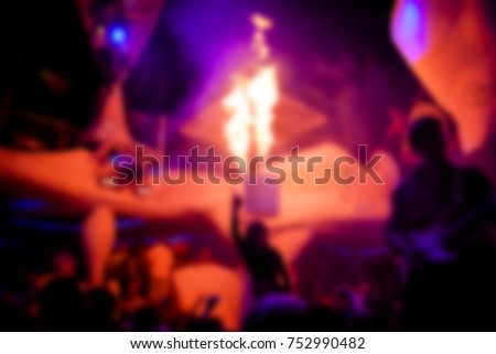 Blurred for background. Night club dj party people enjoy of music dancing sound with colorful light with Smoke Machine and lights show. Fire show in club.