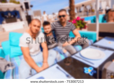 Blurred for background. Men relaxing in luxury beach resorts during summer holidays. The boy has rest on day lounge party at elite beach resorts