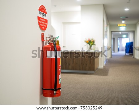 Dry chemical powder fire extinguisher in corridor