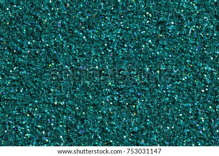Contrast dark turquoise background with glitter. High resolution photo.
