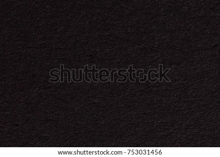 Black paper texture or background with spotlight, dark tone. High resolution photo.