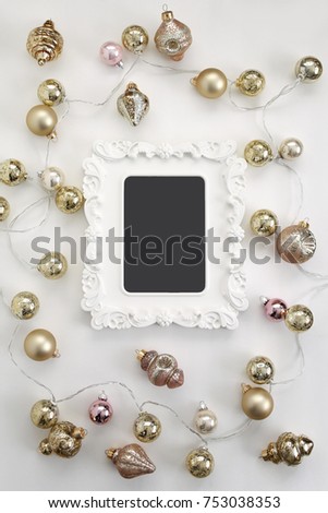 Pink and Gold Vintage Ornaments, Antique Mercury Glass String Lights, and Empty Blank White Frame Flat lay composition for bloggers, magazines, social media and artists. Top view.