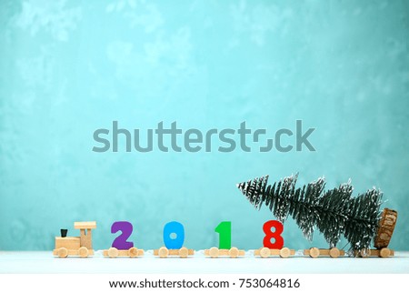 2018 happy new year,wooden toy train carrying numbers and Cristmas tree