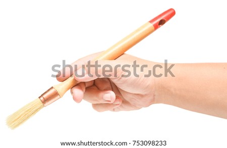Hand holding a brush isolated on white background.