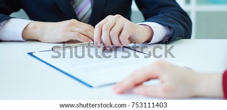 Closeup of businessman explaining  to his new business partner the terms of the agreement or contract. With depth of field image.