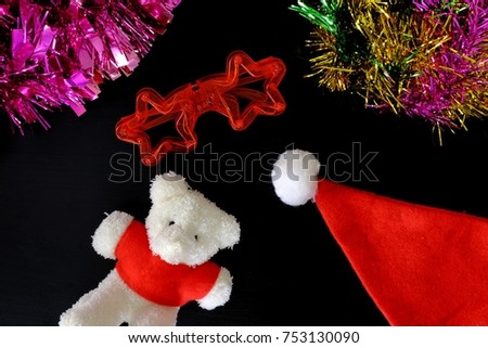Christmas background with bear and decorations on on black background.