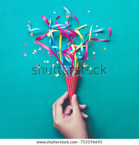 Celebration,party backgrounds concepts ideas with hand holding colorful confetti,streamers.Flat lay design
