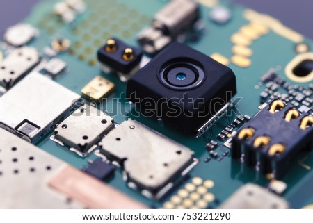 Close up view of camera inside smart phone and motherboard Horizontal